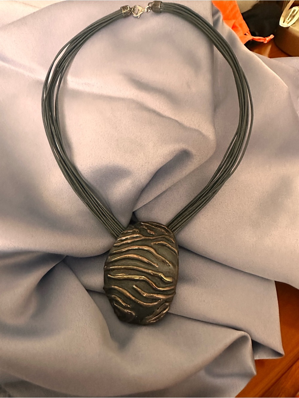 Artisan Multi-Strand Cord Statement Necklace with Textured Metallic Oval Pendant